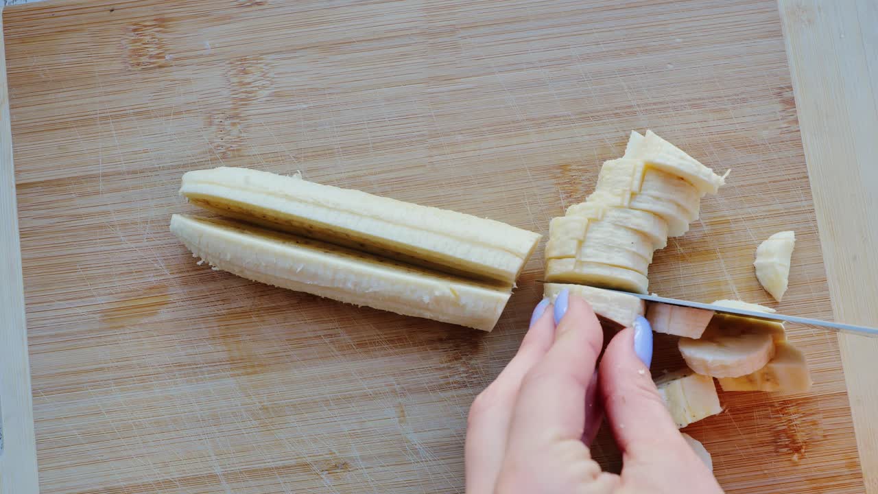 Ripe banana cut on wooden surface highlights fresh snack preparation