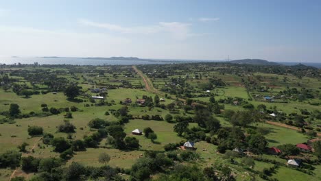 Drone-shot-over-green-landscapes-in-Muhuru-Bay-with-Lake-Victoria-visible-in-the-foregound