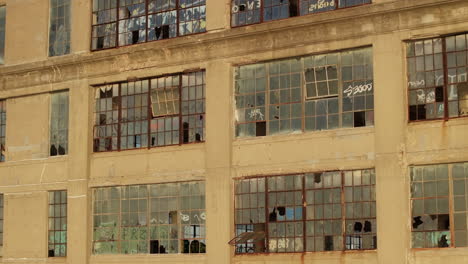 aerial view of the exterior of an abandoned warehouse at sunset.