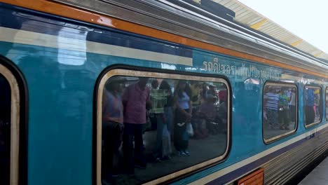 train arrives at bustling kanchanaburi platform