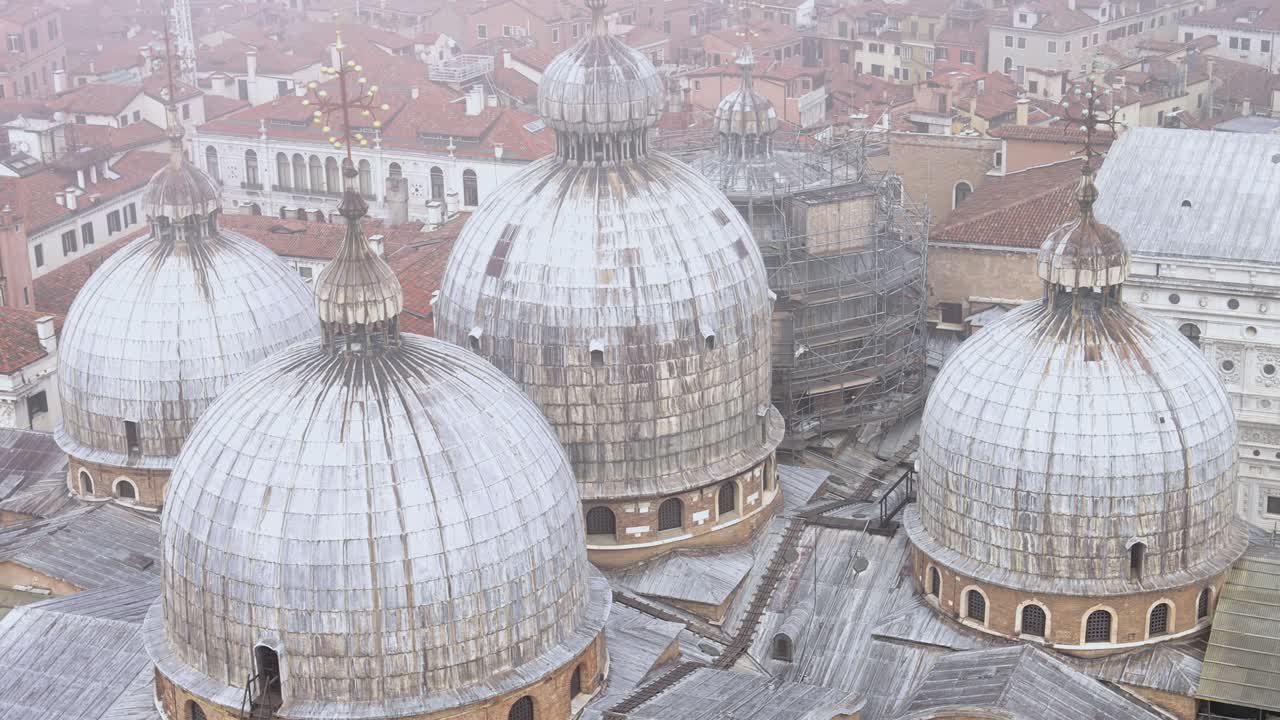 Aerial static view of apse domes of saint marks basilica fog rolls in and out