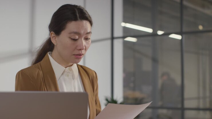 Businesswoman Interviewing Off Camera Candidate For Job In Office 3