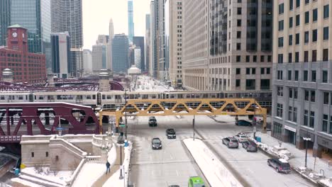 fixed aerial shot - subway train crossing busy street - downtown chicago