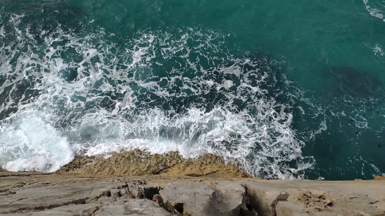 Waves crash below rocky cliffs in Guadamia, Asturias, creating a wild, dramatic view