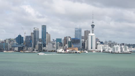 auckland city view and central business district across the harbour with overcast skies