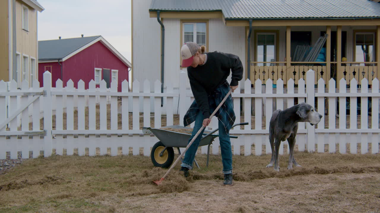Woman Gardening in Yard with Dog