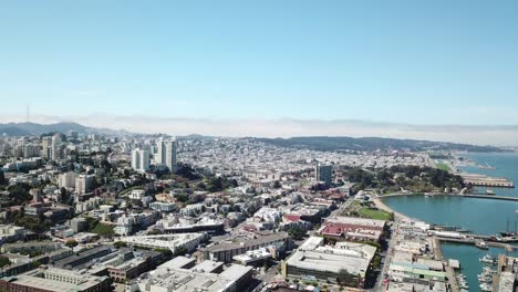 Aerial-flyover-of-Fisherman's-Wharf-bay-to-a-San-Francisco-Neighborhood,-USA