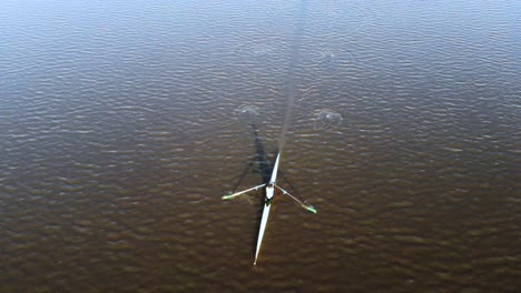 man paddling kayak on a river