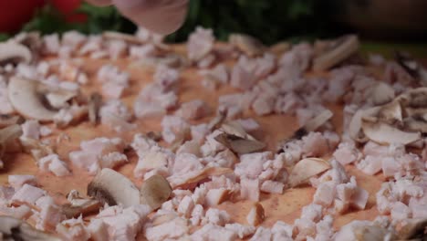 preparing a pizza with mushrooms and chicken