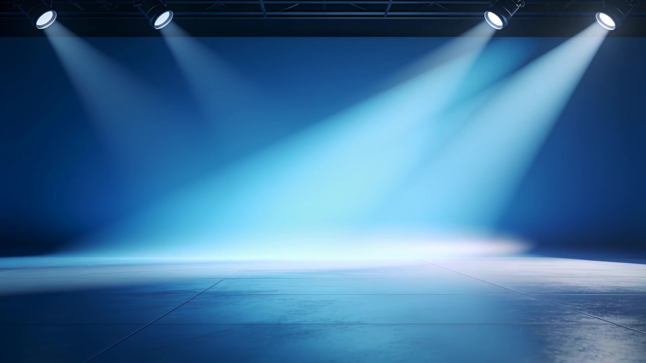 Moving 3 overhead blue lights sweeping beams across polished stage floor, control cue prepping show