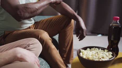 wife taking the remote control from her husband's hand