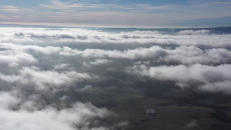 aerial view above clouds massif central valley fields sunny day france