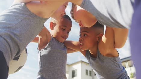 Video-of-happy-diverse-boys-holding-arms-and-talking