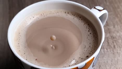 closeup of ultra slow motion drops falling into a coffee