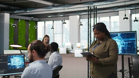 smiling engineer next to office coworkers developing ai software applications