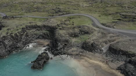 famous skardsvik beach with turquoise water and sandy beach in iceland, aerial