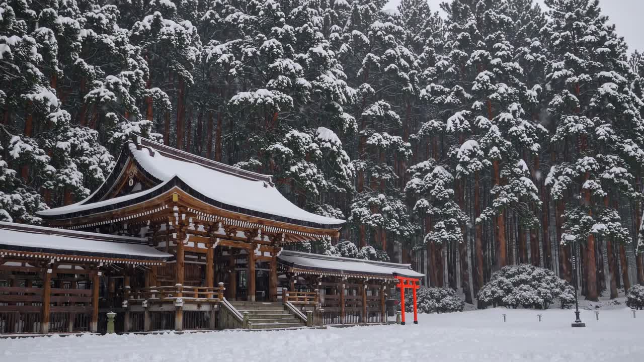 A serene winter scene of a traditional Japanese shrine surrounded by snow-covered trees