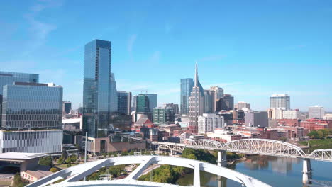 drone decends to show downtown nashville skyline from the cumberland river