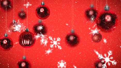 Animation-of-snow-falling-over-christmas-decorations-on-red-background