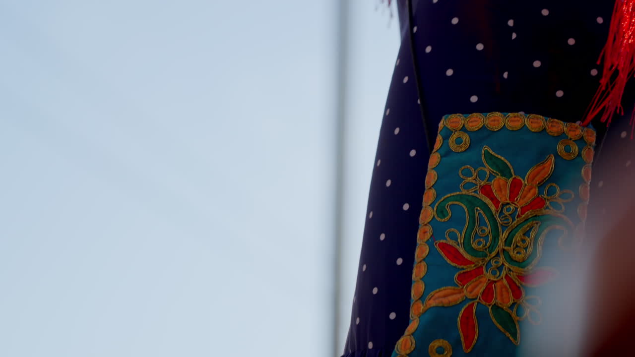 Vibrant red flamenco dress with playful fringes glowing under the afternoon sun at Seville's April Fair