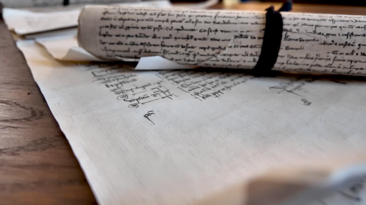Ancient parchment manuscript displaying historical English text and a wax seal