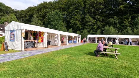 outdoor market with various stalls and visitors