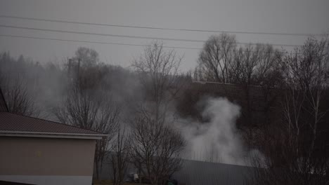 fire-in-a-private-house-thick-smoke-rises-above-the-roofs.