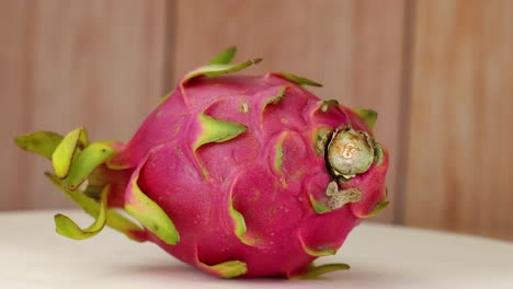 dragon fruit rotating on a wooden surface