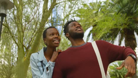 Couple-interacting-with-each-other-while-walking-in-the-park-4k