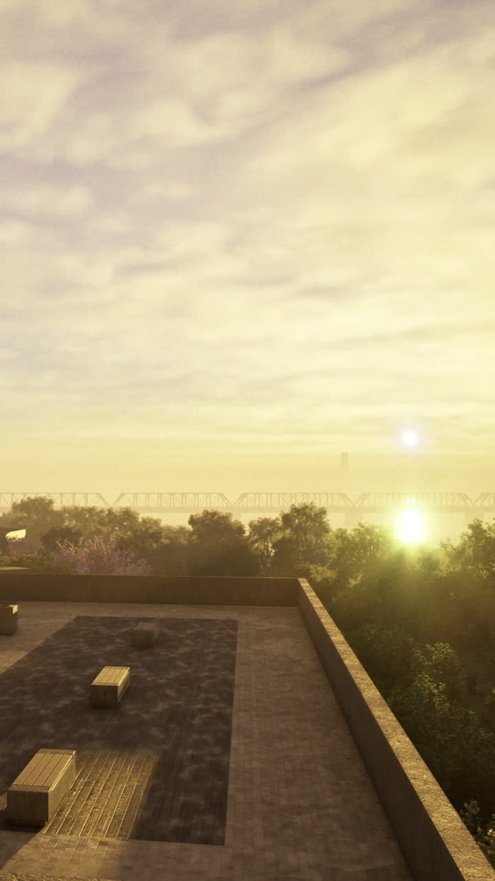 Vista do nascer do sol de um telhado com árvores e uma ponte distante pela manhã.