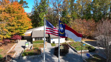 america and north carolina flags waving at north carolina welcome center along interstate highway