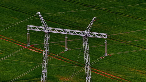 a steel transmission tower supports 110 kv power lines over a green field—key to the energy grid.