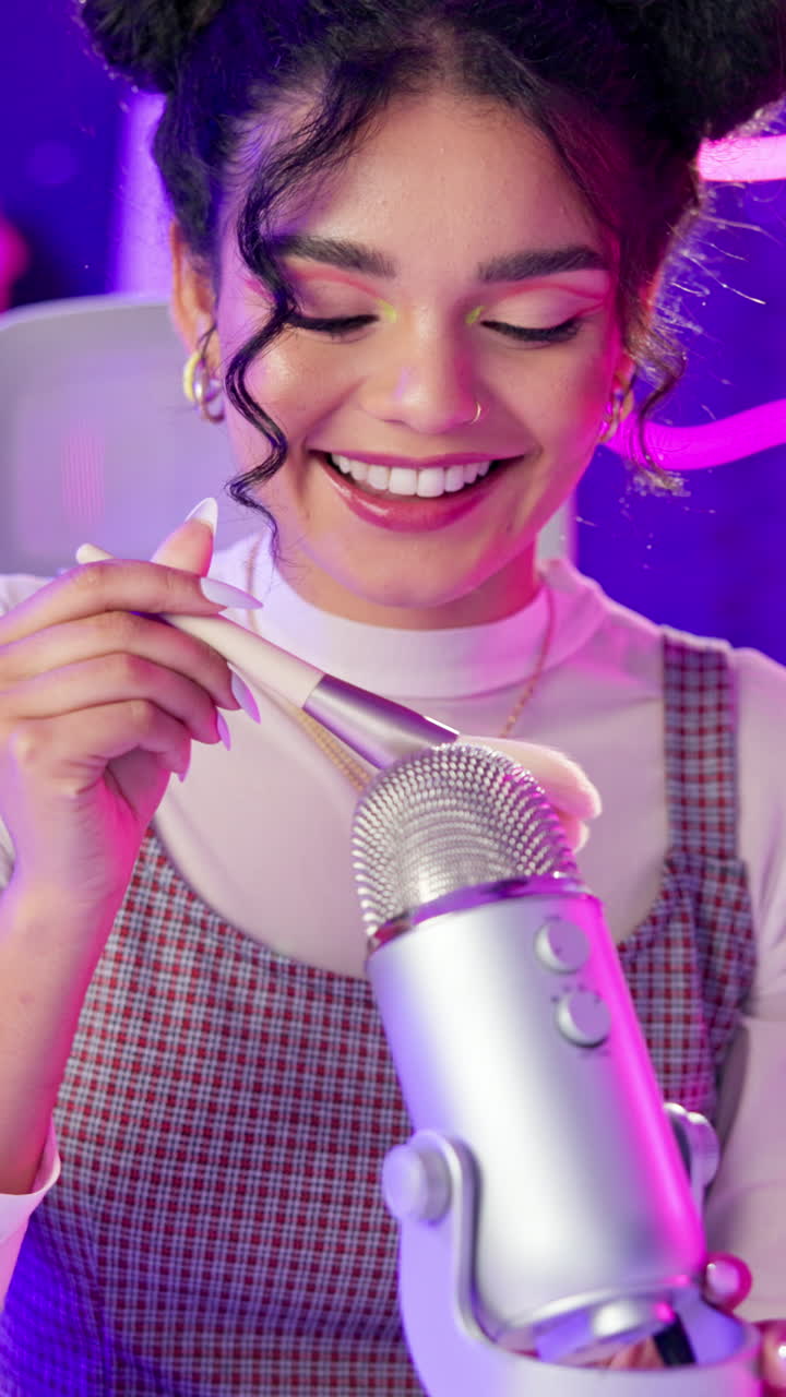 A woman with makeup and a microphone