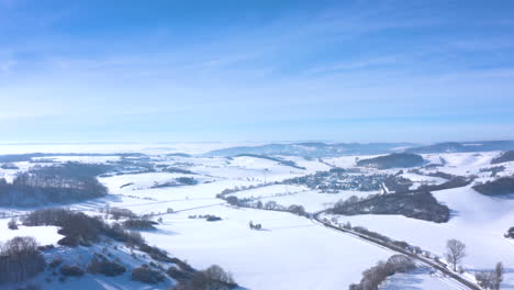 Small-Town-In-The-Middle-Of-Snowy-Landscape---aerial