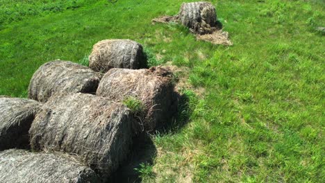 Haystacks-on-green-fields,-aerial-view