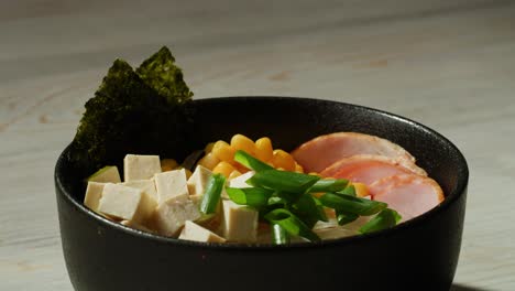 delicious bowl of ramen with tofu, corn, and pork