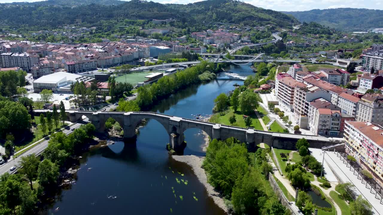 Backward aerial revealing apartments on the banks of the Mi&ntilde;o river