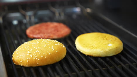 top view of the delicious burger cutlet and fresh buns grilled on barbeque. delicious dish freshly made on grid.