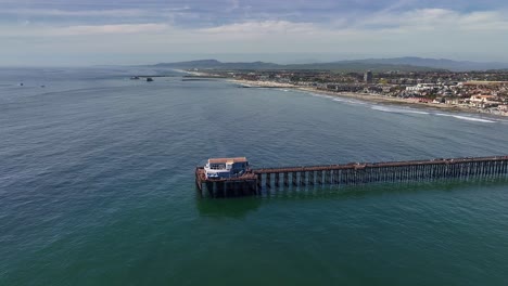 Aerial-shot-panning-around-the-end-of-the-Oceanside-Ca-Pier