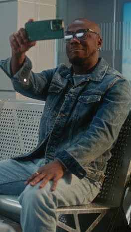 man taking selfie in a station