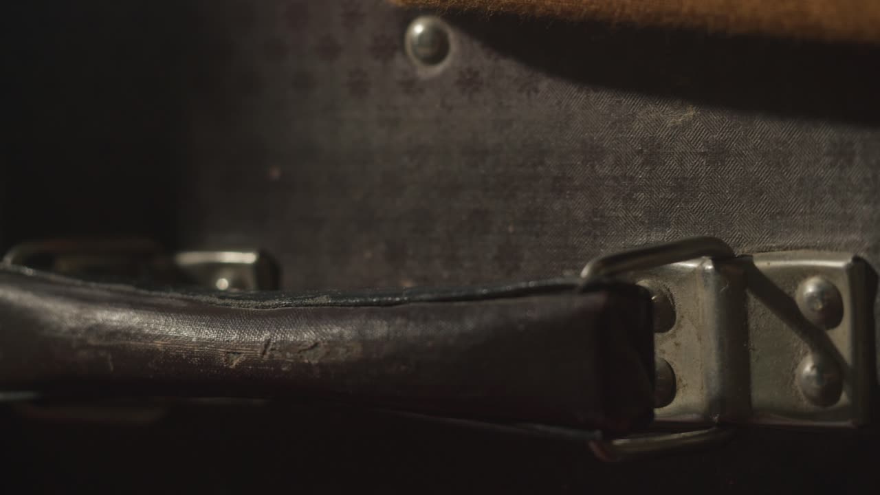 Close Up Panning Shot of a Vintage Suitcase Handle and Lock