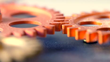 close up on clock 's mechanism: wheels spinning together