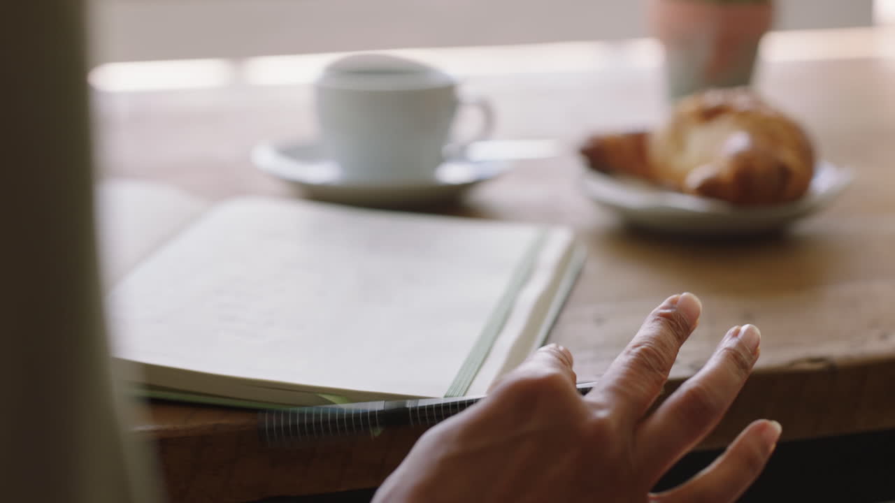 Woman hands writing notebook in cafe for creative
