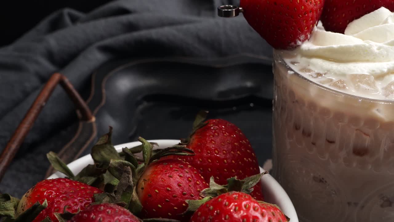 Pink cocktail drink with strawberry liqueur, vanilla vodka and cream. Party drink with strawberries. Fruit cocktail with fresh strawberries as a garnish. Cold and refreshing