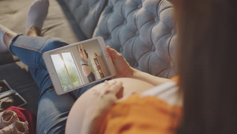 pregnant woman watching online prenatal exercise video