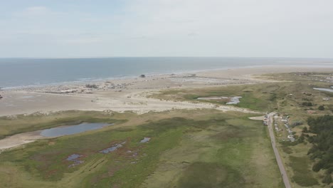 drone - aerial shot of the green and sandy nature beach of st. peter ording at the north sea, schleswig holstein, germany, 30p