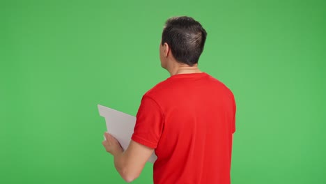 Technician with his back turned taking notes