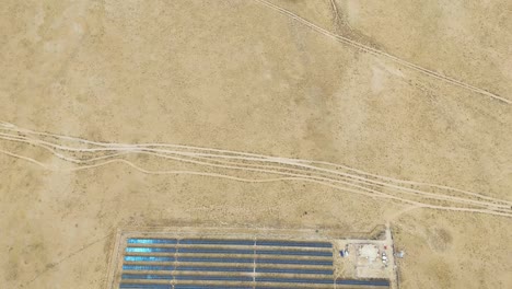 aerial view of a remote solar panel farm in the desert