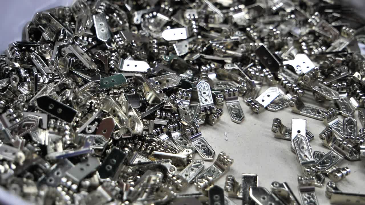 A Pile of Small Metal Hinges