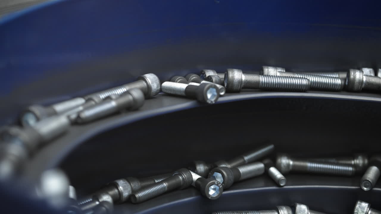 Close-up of screws in a blue container